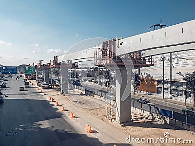 Evening traffic on Ramintra Road is the construction area of â€‹â€‹the Pink Line Electric Train Project Editorial Stock Photo